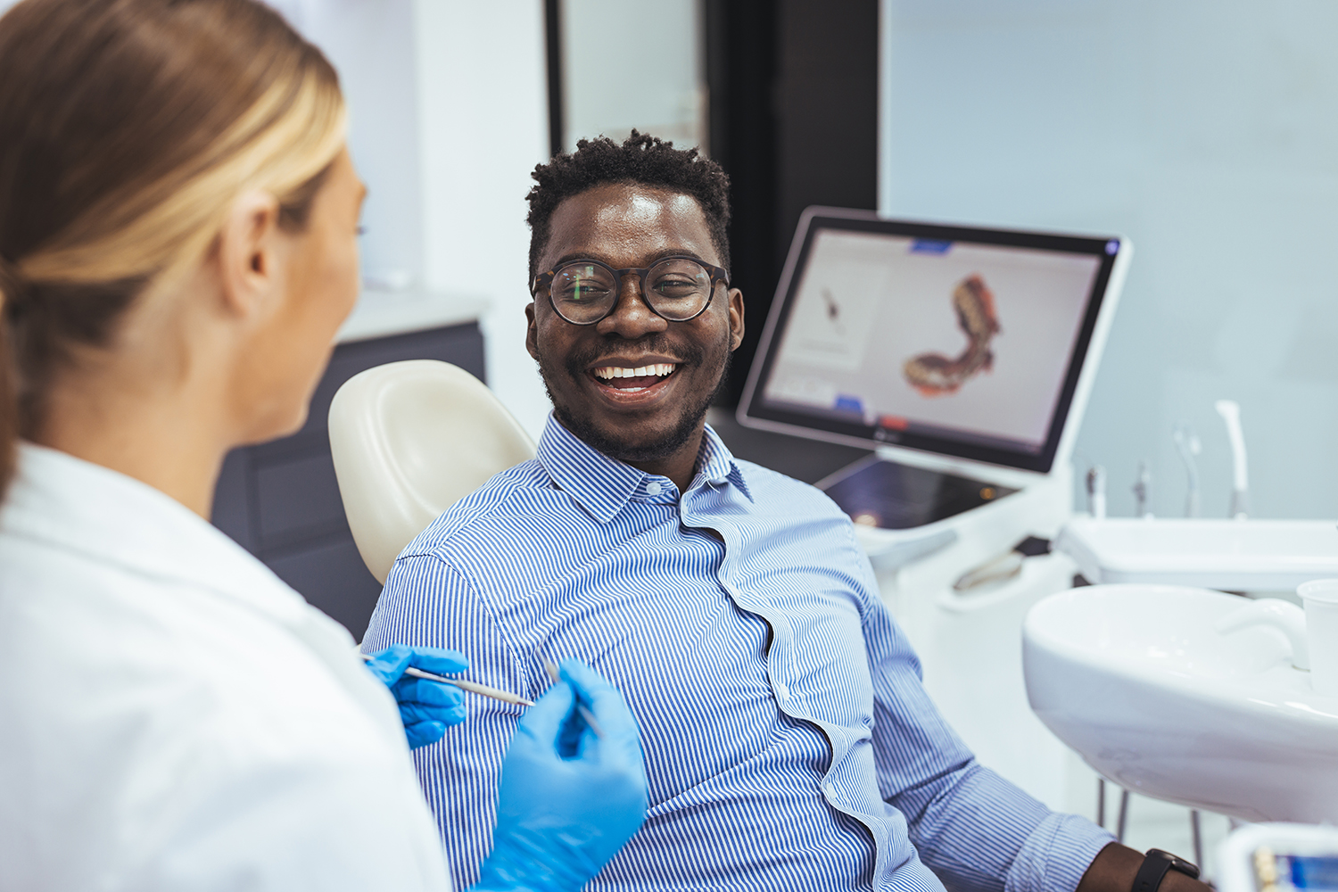 Dentist explaining restorative treatment options to a smiling patient in North Tampa
