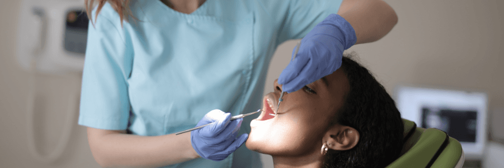 A dental hygienist performs a cleaning to help maintain a healthy smile.