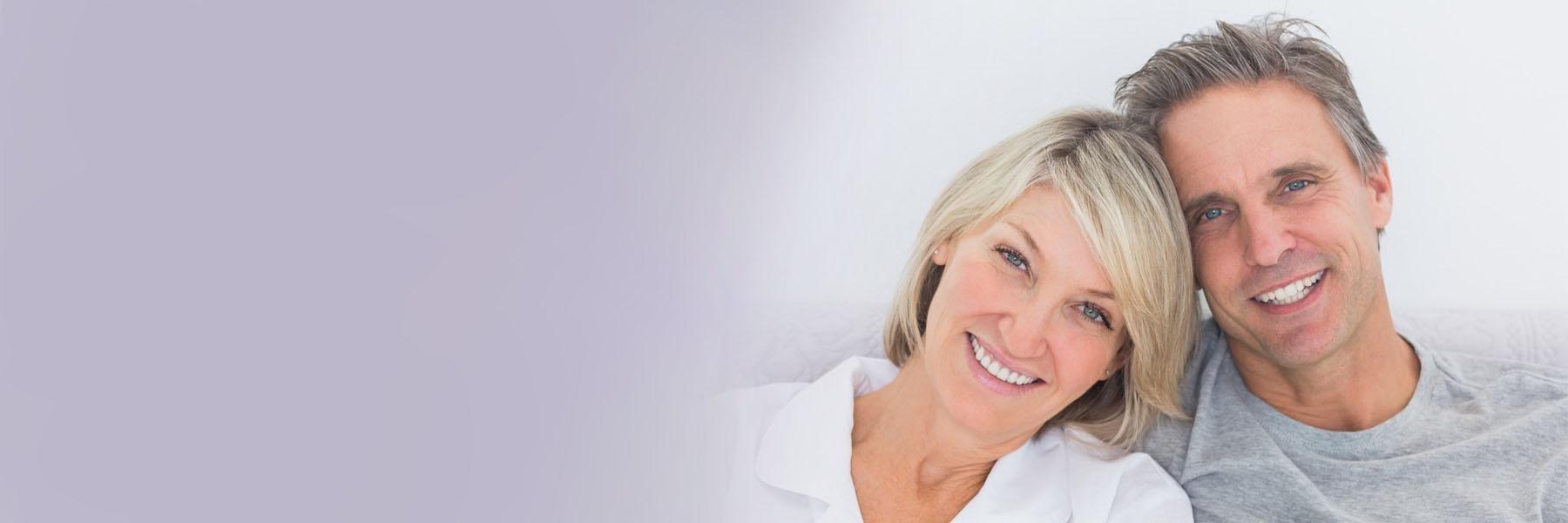 Patients showing of their brand new implant dentures in Tampa, FL